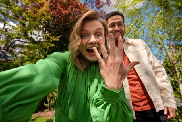 Happy couple selfie showing engagement ring